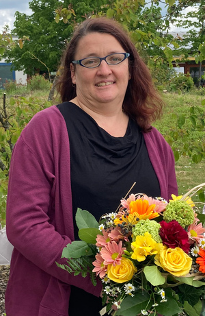 Maria Prechtl mit einem Blumenstrauß in der Hand.