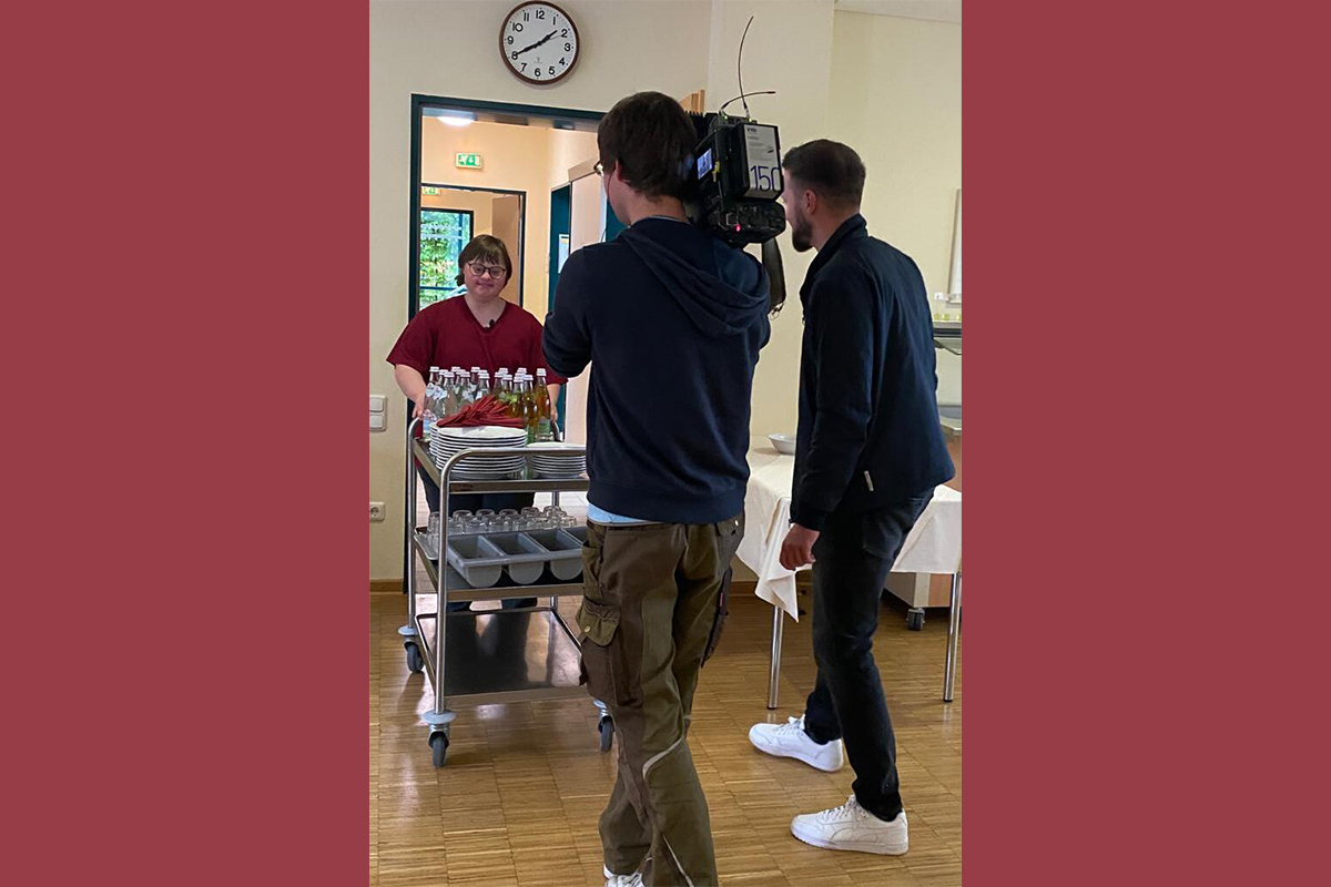 Mitarbeiter und Filmteam rund um einen Tisch