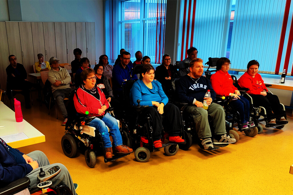 Die Mitarbeiterinnen und Mitarbeiter schauen bei der Prüferschulung interessiert zu .